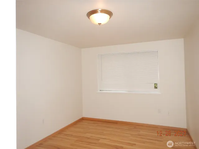a view of a room with wooden floor and fan