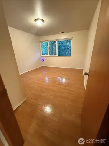 a view of an empty room with windows