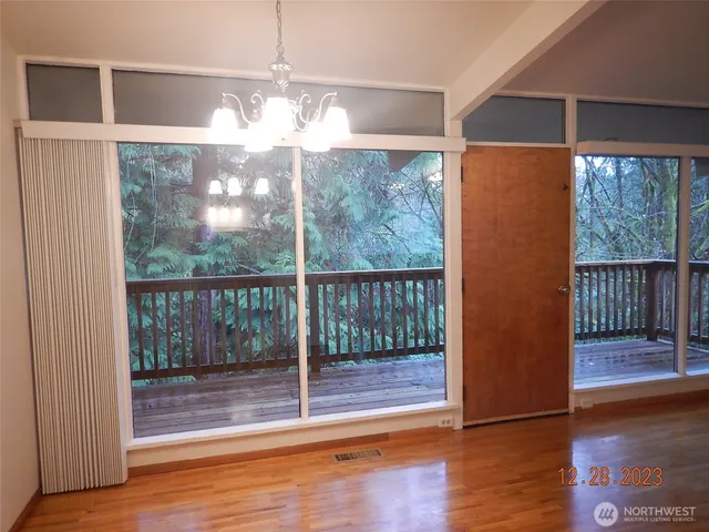 a view of a room with wooden floor and city view