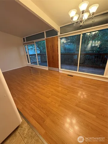 a view of an empty room with glass door