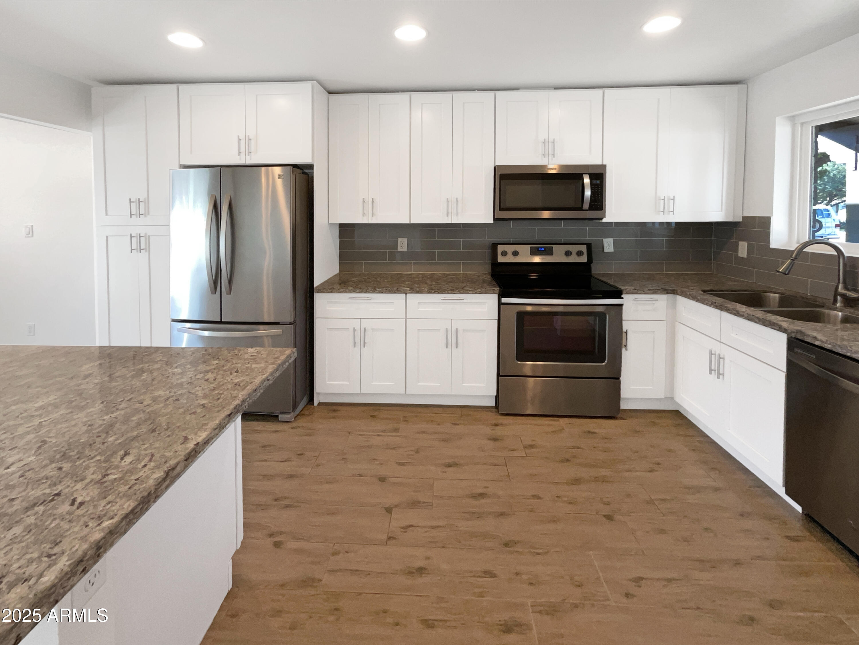 7231 North 23rd Avenue Phoenix, AZ 85021 - Photo 8 of 28 a kitchen with granite countertop a stove and a refrigerator