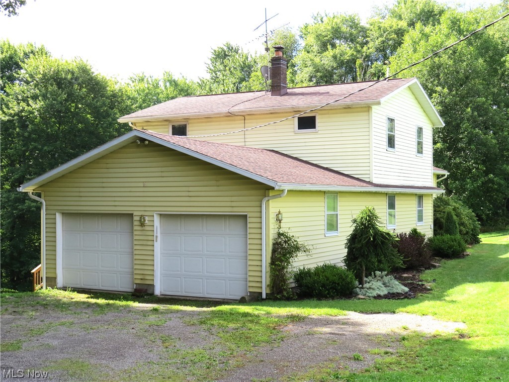 10130 Lee Road Minerva, OH 44657 - Photo 2 of 35 North end of house with 2 car attached garage.
