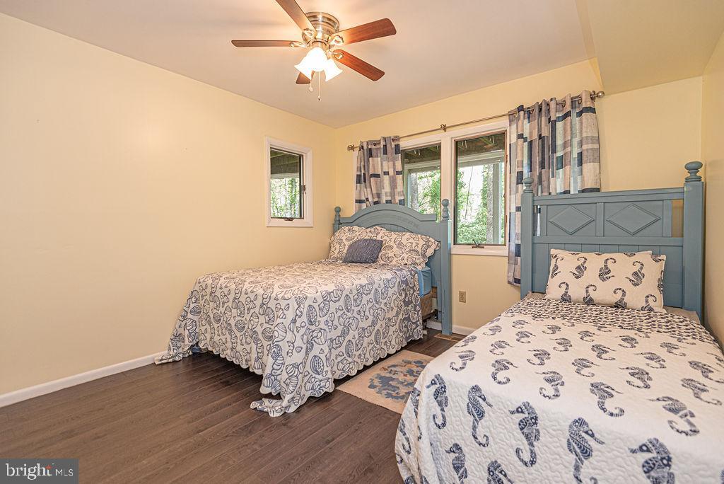 63 Drawbridge Road Ocean Pines, MD 21811 - Photo 57 of 102 a bedroom with two beds and a chandelier
