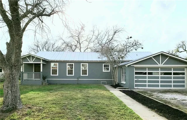 front view of a house with a yard
