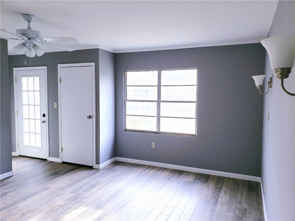 Undisclosed Address George West, TX 78022 - Photo 8 of 13 an empty room with wooden floor and windows