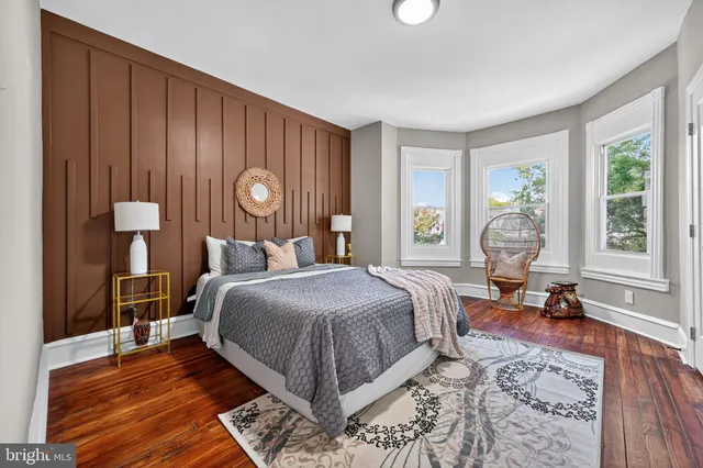 a bed room with a bed and a large window