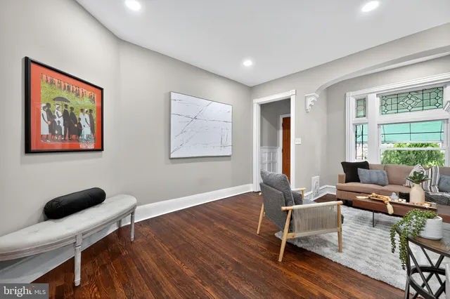a living room with furniture a table and a large window