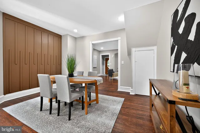 a view of a a dining room with furniture window and wooden floor