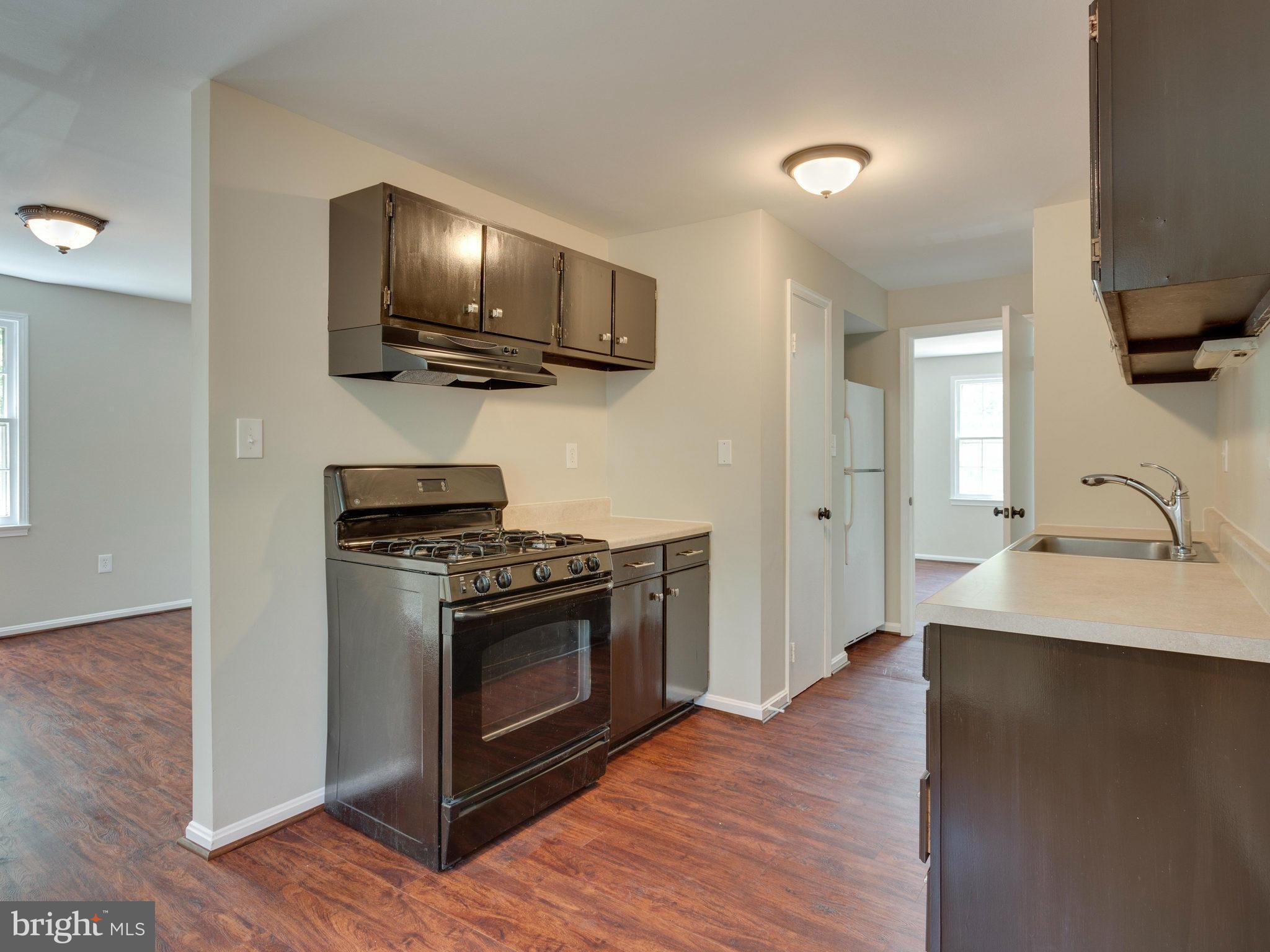 13133 Putnam Circle Woodbridge, VA 22191 - Photo 13 of 30 a kitchen with stainless steel appliances a stove a microwave and a hard wood floors