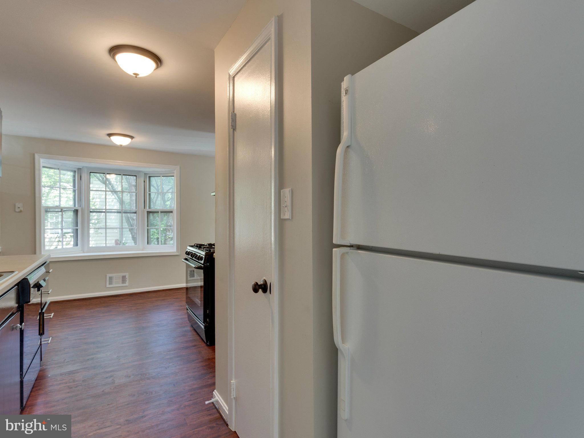 13133 Putnam Circle Woodbridge, VA 22191 - Photo 15 of 30 a view of an empty room with a window and wooden floor