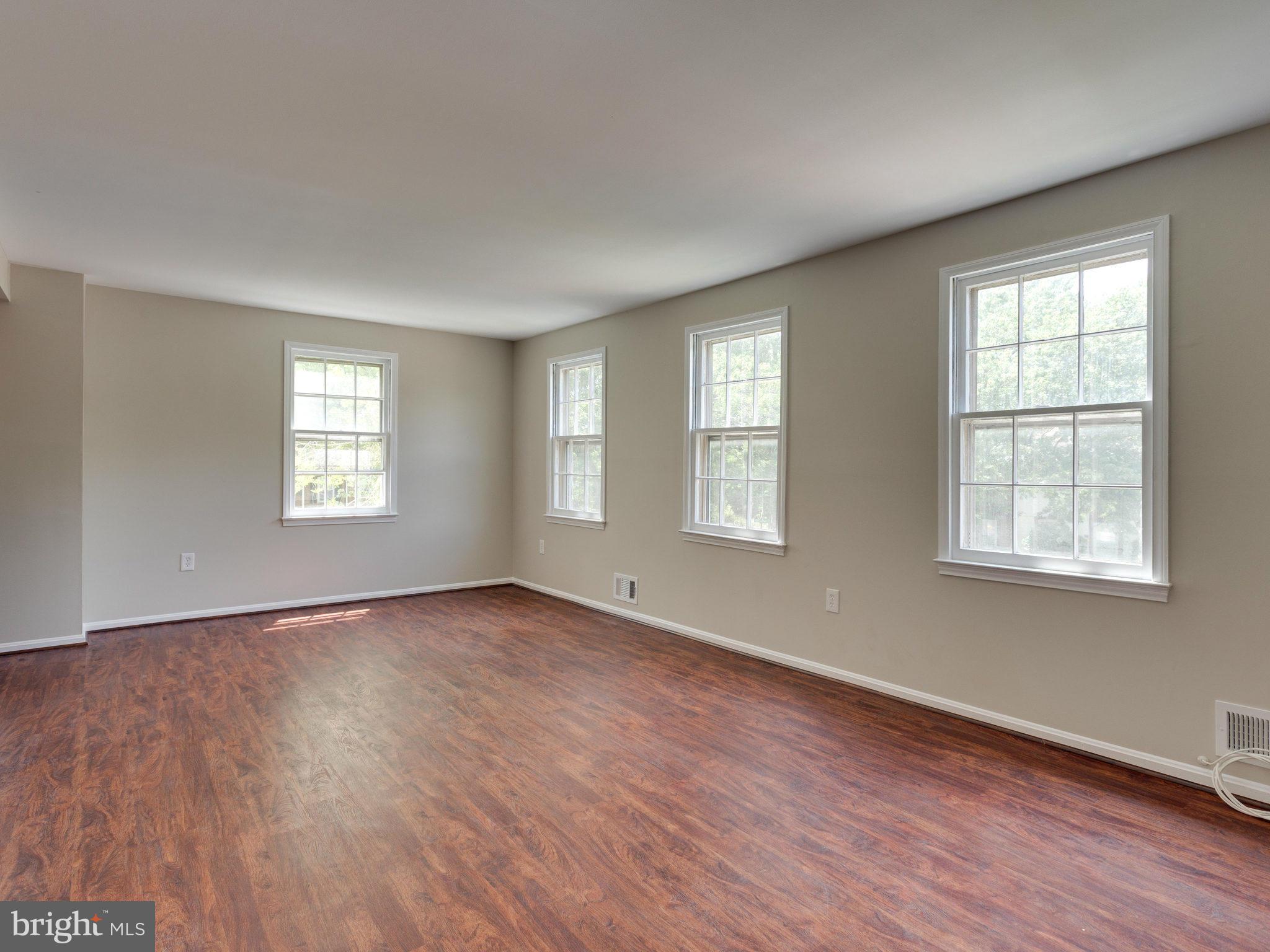 13133 Putnam Circle Woodbridge, VA 22191 - Photo 17 of 30 an empty room with wooden floor and windows