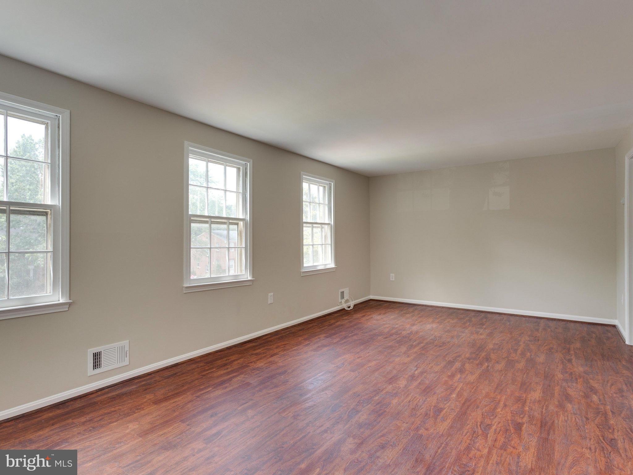 13133 Putnam Circle Woodbridge, VA 22191 - Photo 18 of 30 an empty room with wooden floor and windows