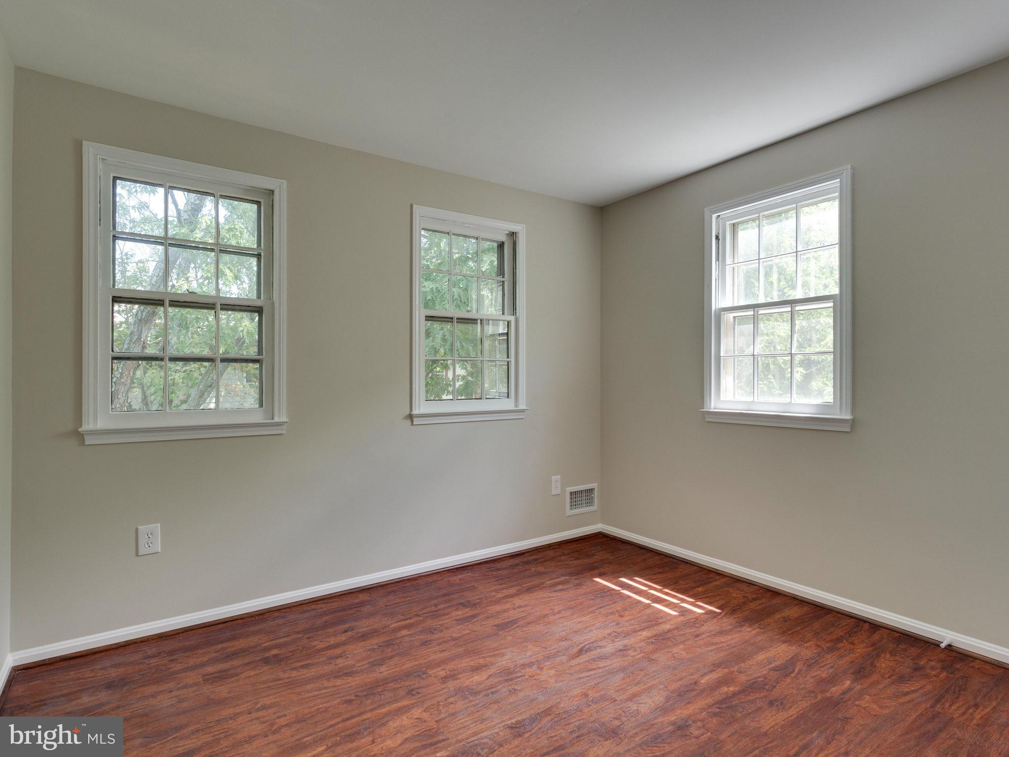 13133 Putnam Circle Woodbridge, VA 22191 - Photo 20 of 30 an empty room with wooden floor and windows