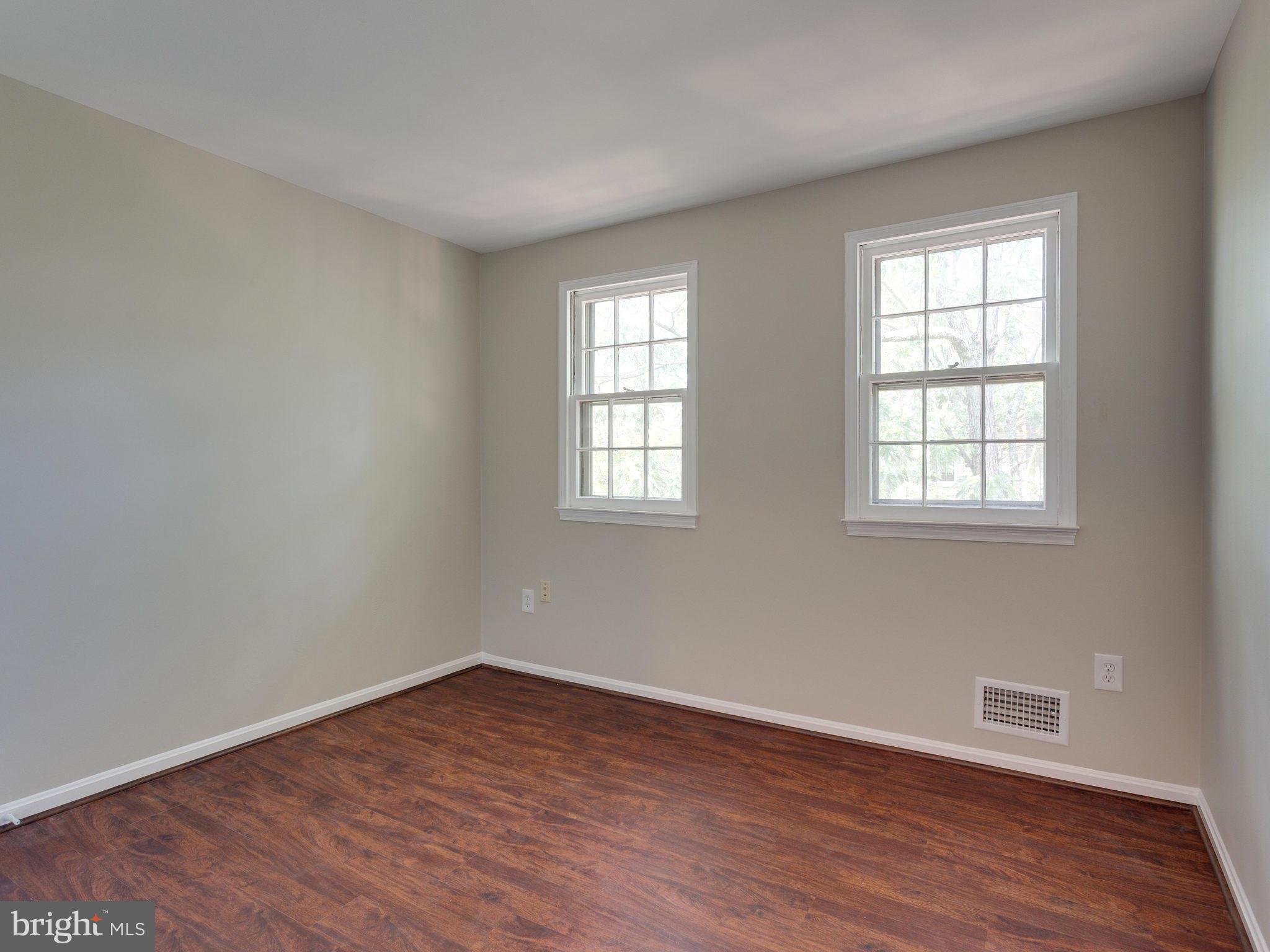 13133 Putnam Circle Woodbridge, VA 22191 - Photo 22 of 30 an empty room with wooden floor and windows