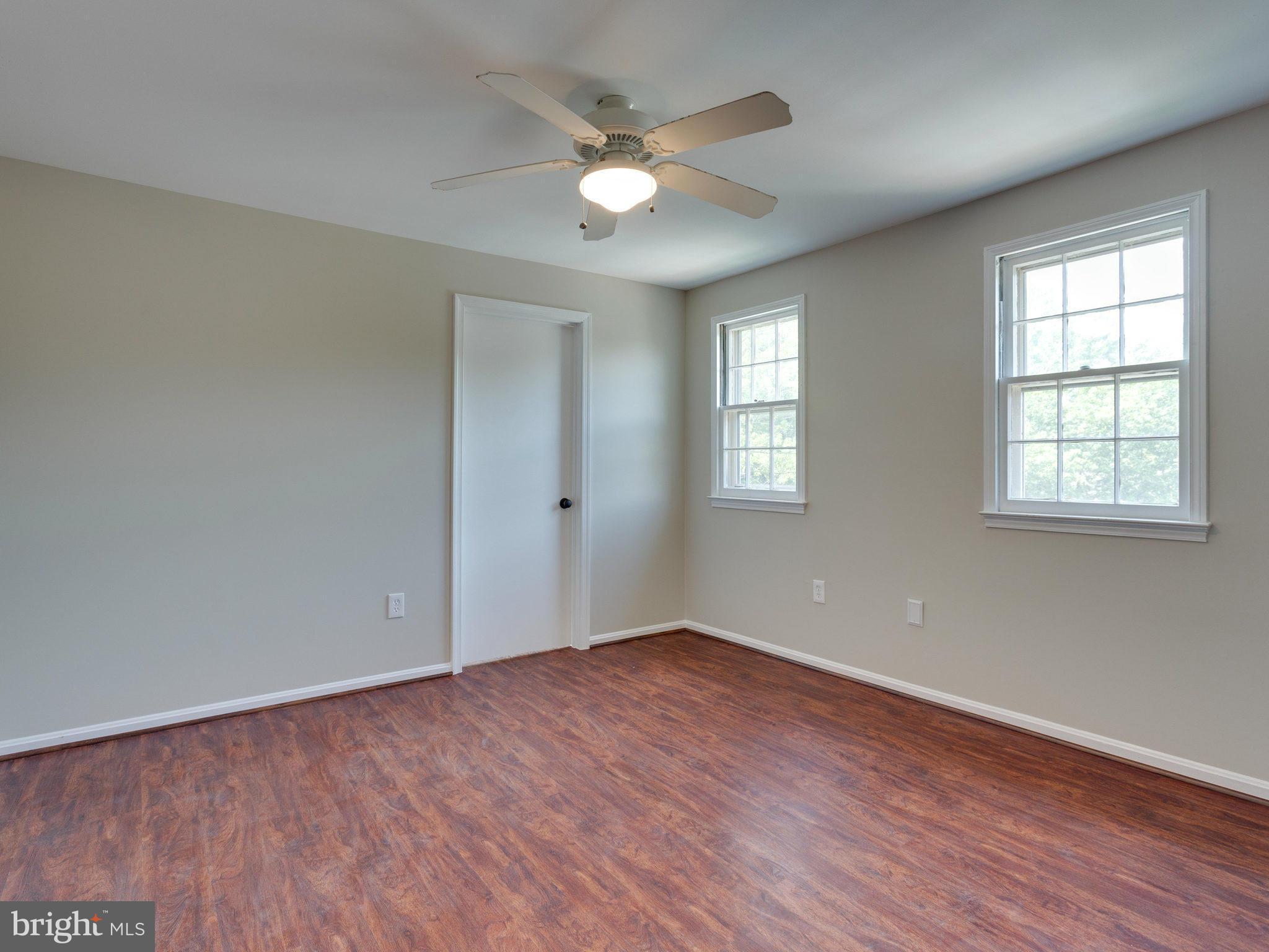 13133 Putnam Circle Woodbridge, VA 22191 - Photo 24 of 30 an empty room with wooden floor and windows