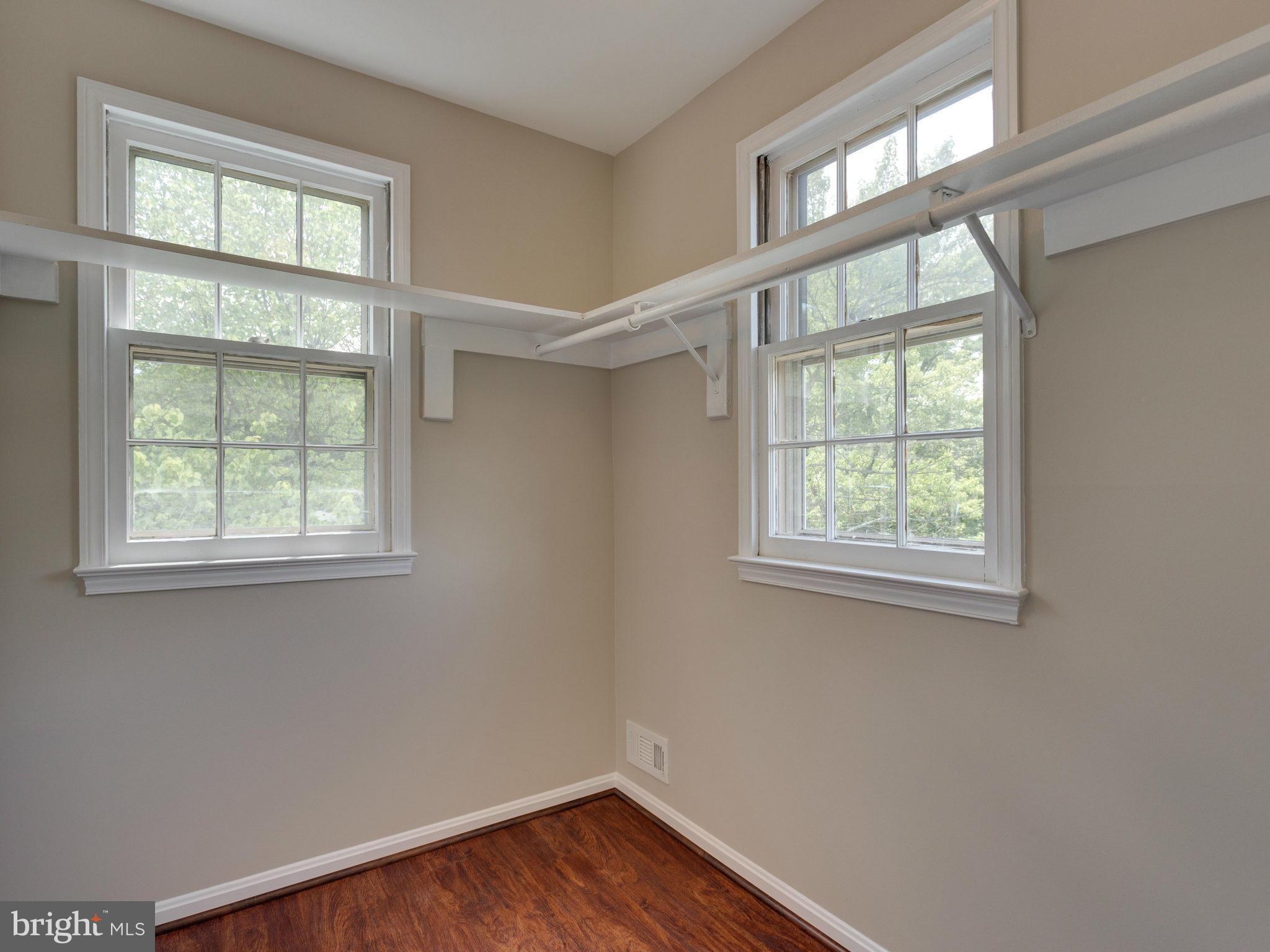 13133 Putnam Circle Woodbridge, VA 22191 - Photo 27 of 30 an empty room with wooden floor and windows