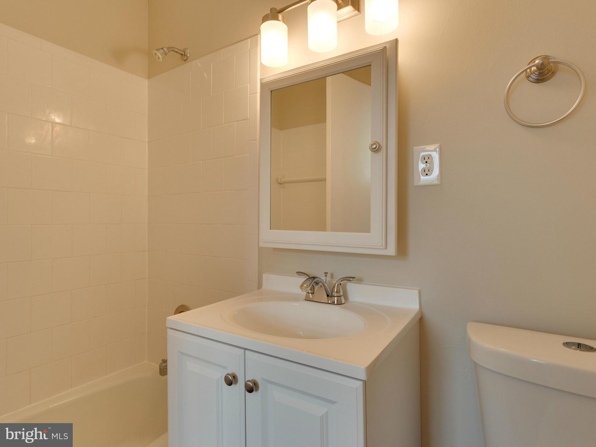 13133 Putnam Circle Woodbridge, VA 22191 - Photo 29 of 30 a bathroom with a sink a toilet and mirror