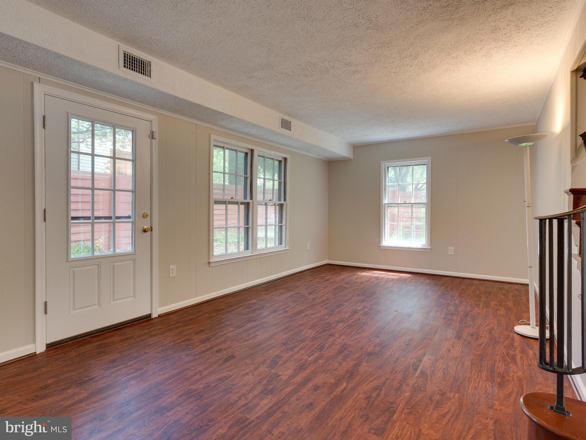 13133 Putnam Circle Woodbridge, VA 22191 - Photo 6 of 30 an empty room with wooden floor and windows
