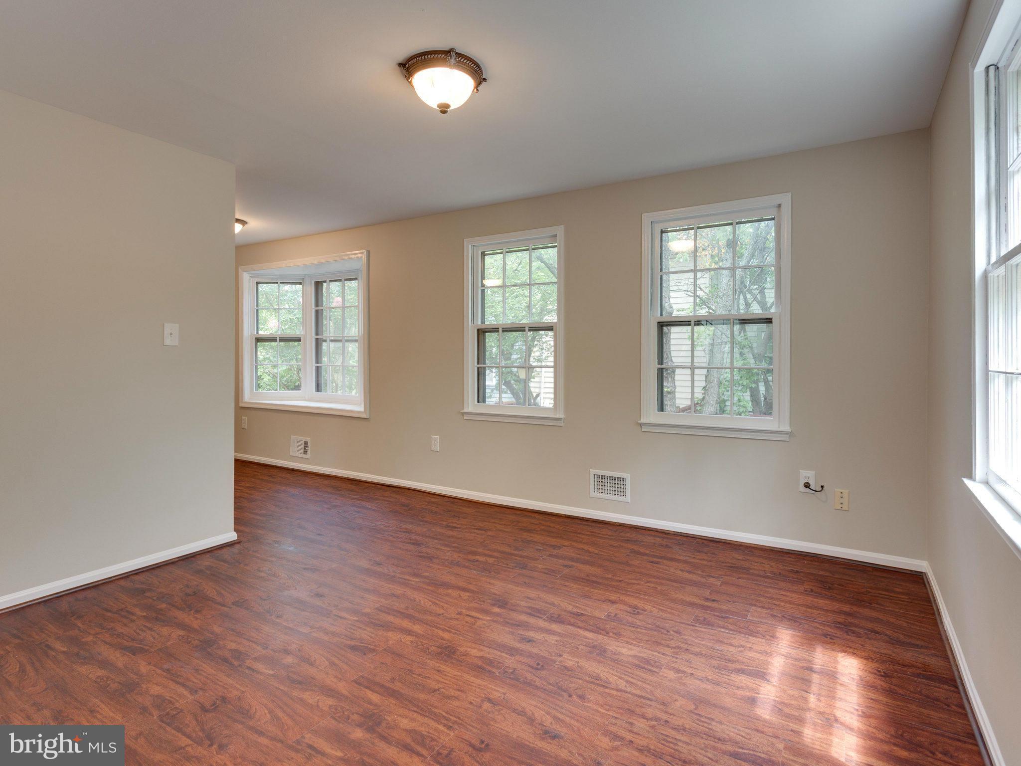 13133 Putnam Circle Woodbridge, VA 22191 - Photo 9 of 30 an empty room with wooden floor and windows