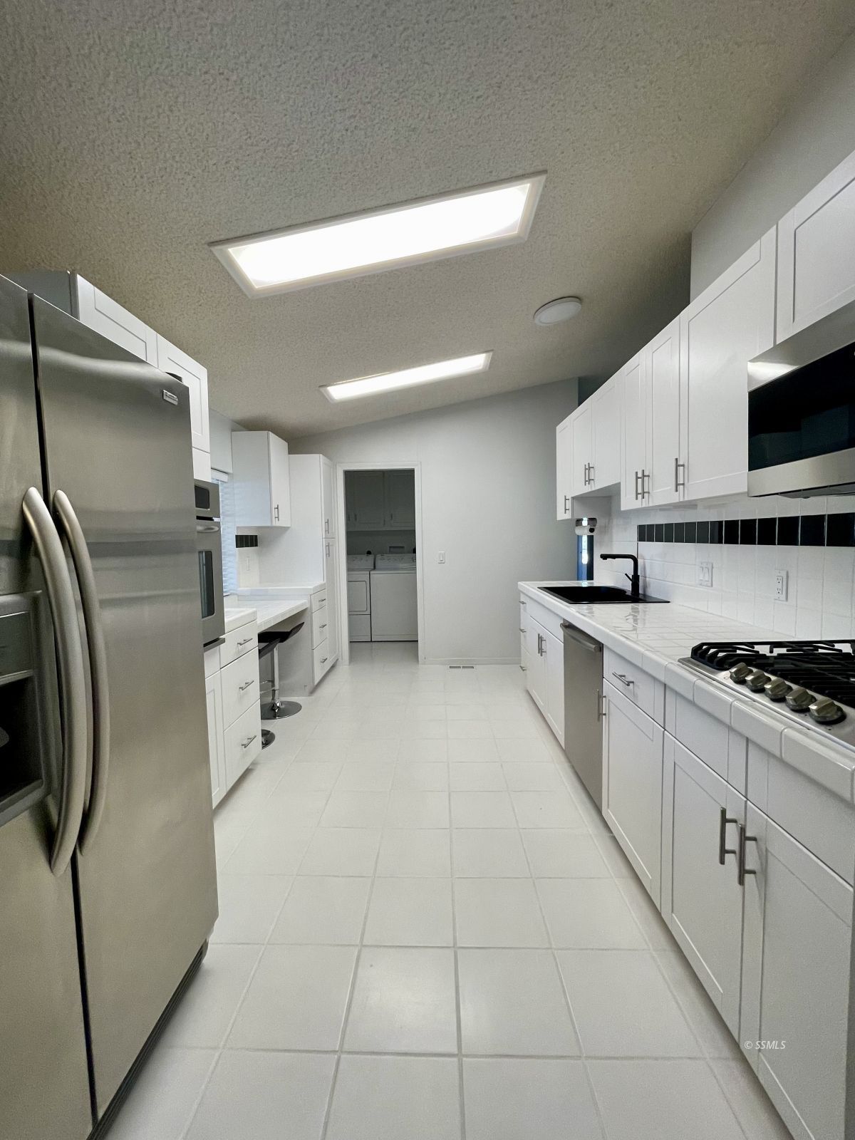 1449 Dunes Street Ridgecrest, CA 93555 - Photo 12 of 50 a large kitchen with stainless steel appliances granite countertop a stove a sink and a refrigerator