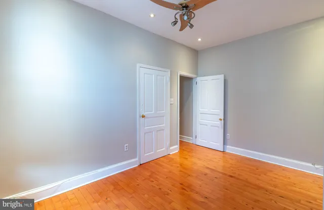 an empty room with a empty space and a ceiling fan