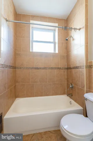 a bathroom with a toilet bathtub and shower