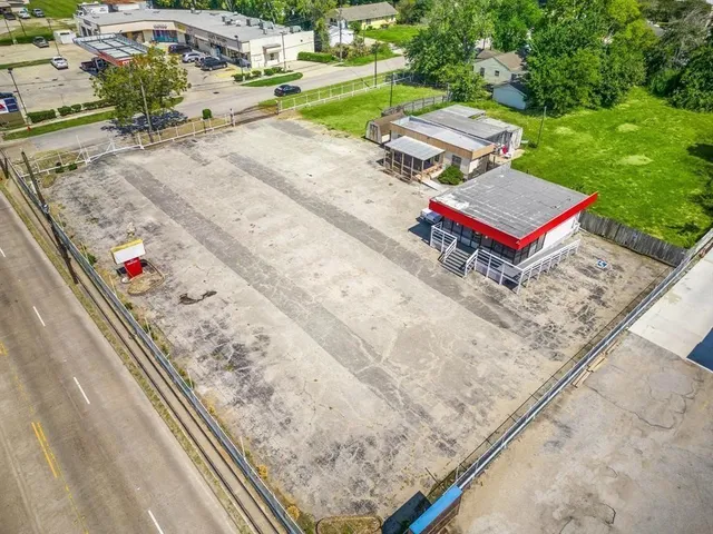 an aerial view of a tennis ground with large trees