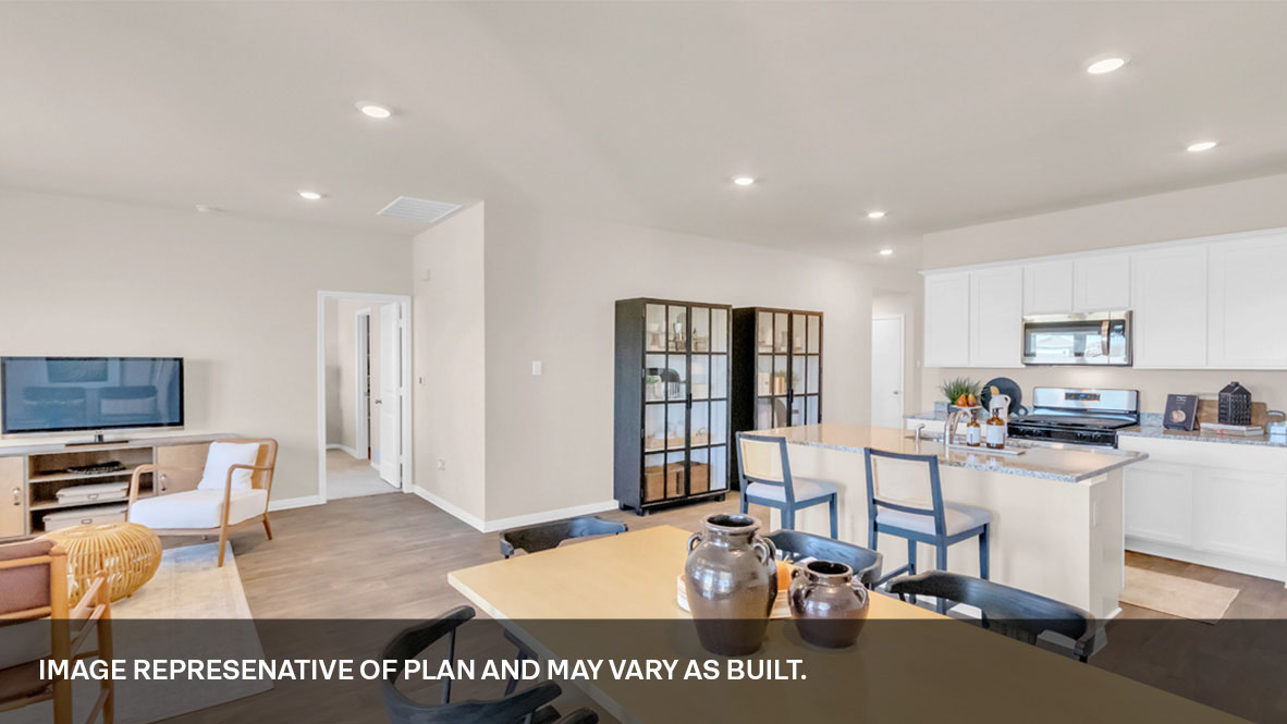 143 Morning Glory Loop Kyle, TX 78640 - Photo 20 of 34 a living room with stainless steel appliances furniture a rug and a kitchen view