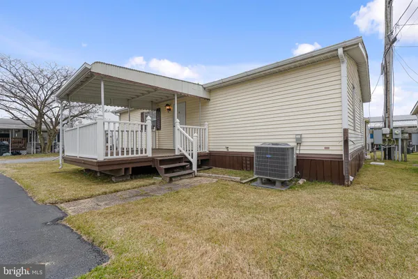a view of a house with a yard and wooden fence