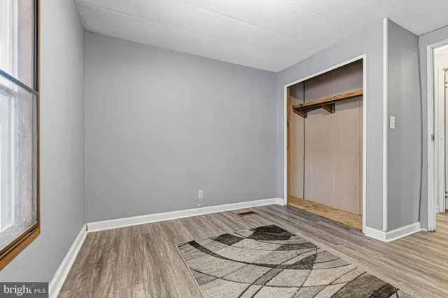 a view of a bedroom with wooden floor
