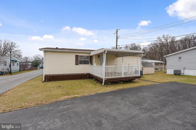 a view of a house with a backyard and garage