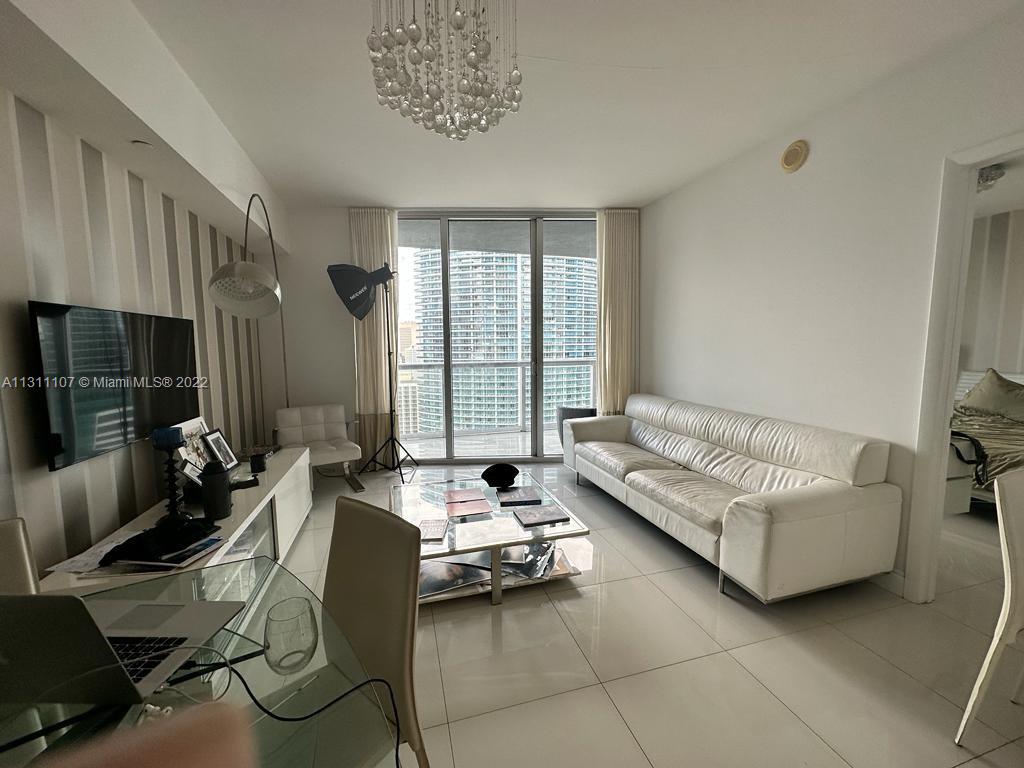 465 Brickell Avenue, Unit 3104 Miami, FL 33131 - Photo 11 of 21 a living room with furniture and a flat screen tv