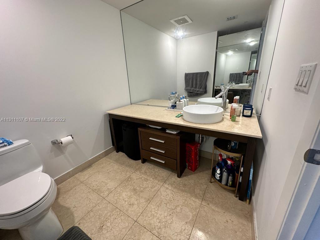 465 Brickell Avenue, Unit 3104 Miami, FL 33131 - Photo 17 of 21 a bathroom with a sink and a mirror