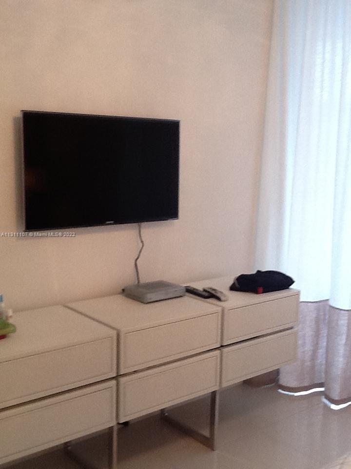 465 Brickell Avenue, Unit 3104 Miami, FL 33131 - Photo 20 of 21 a kitchen with a sink and a flat screen tv