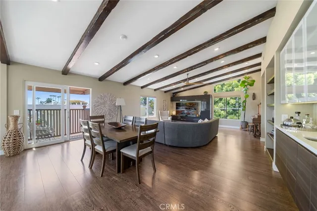 a dining room with furniture window and wooden floor