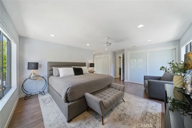 a spacious bedroom with a bed and a couch