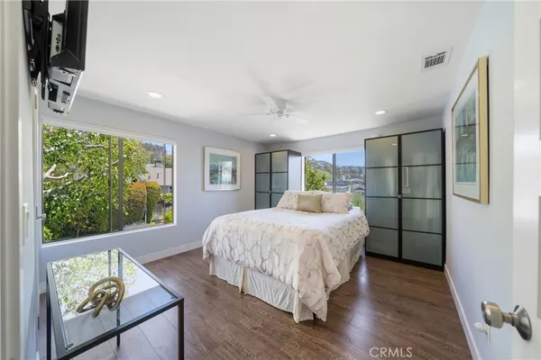 a bed room with a bed window and a dresser