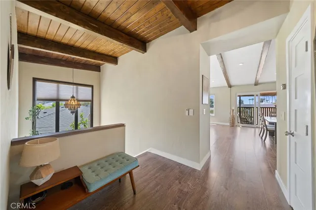 a view of a hallway and wooden floor with dining room