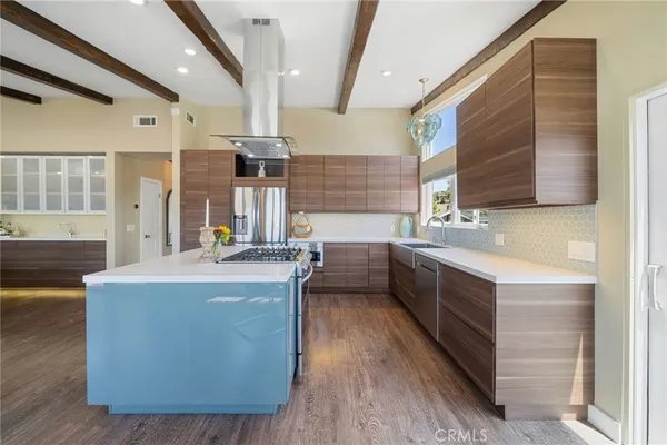 a kitchen with sink cabinets and wooden floor
