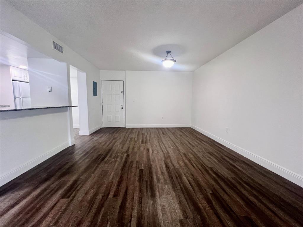 17350 Northwest 68th Avenue, Unit 400416 Hialeah, FL 33015 - Photo 3 of 16 a view of wooden floor in an empty room