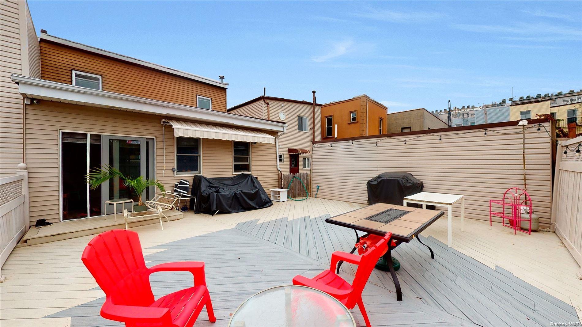 217 Java Street Brooklyn, NY 11222 - Photo 13 of 16 a view of a patio with table and chairs with wooden floor and fence