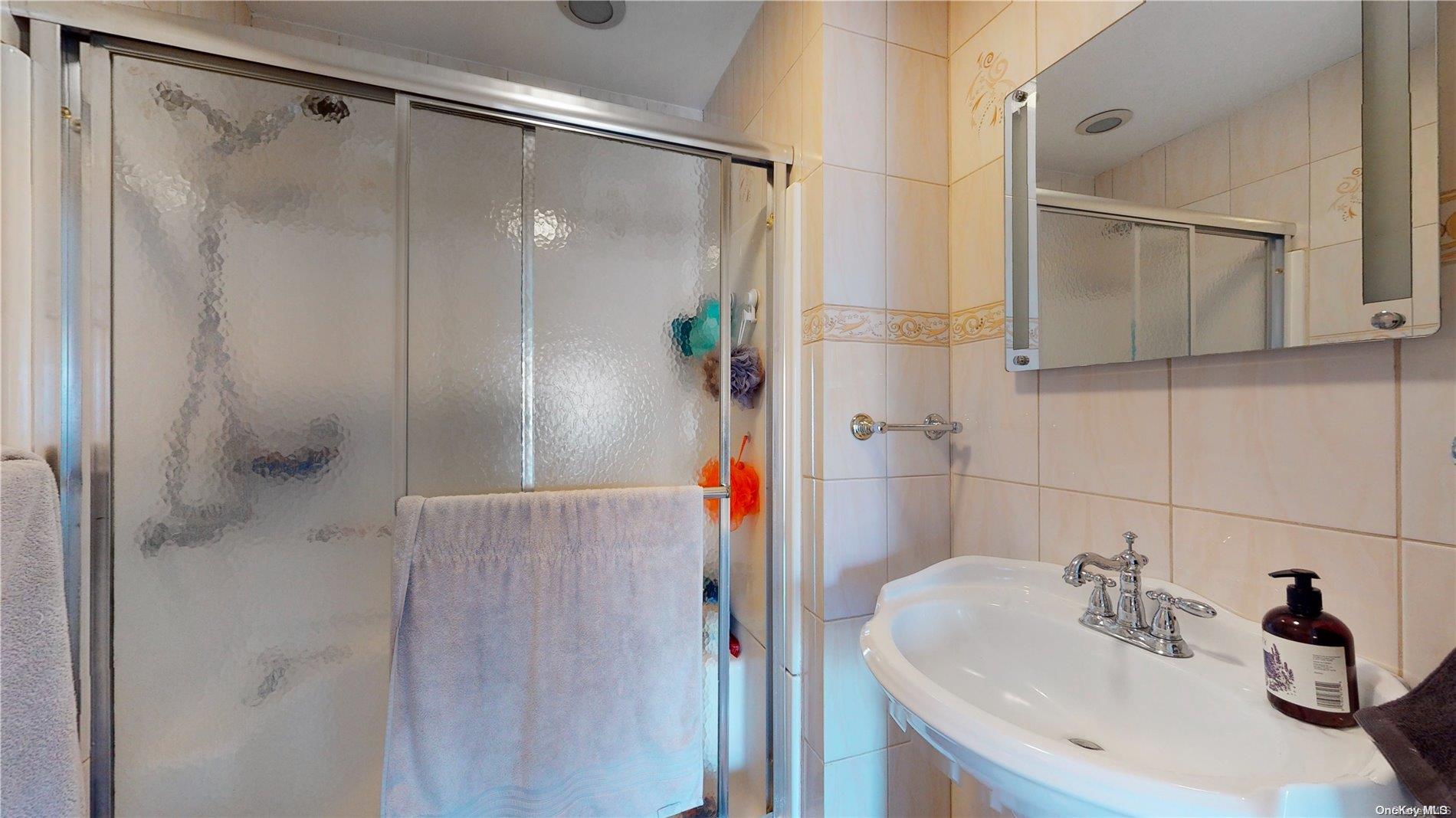 217 Java Street Brooklyn, NY 11222 - Photo 7 of 16 a bathroom with a sink and shower