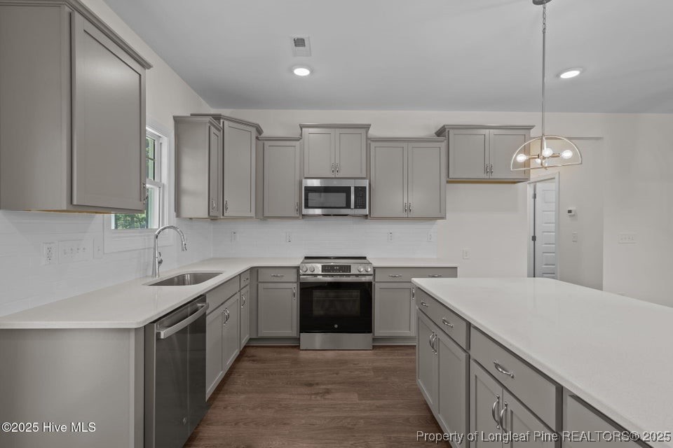 1420 Burning Tree Road Pinehurst, NC 28374 - Photo 21 of 50 a kitchen with a sink stove and microwave
