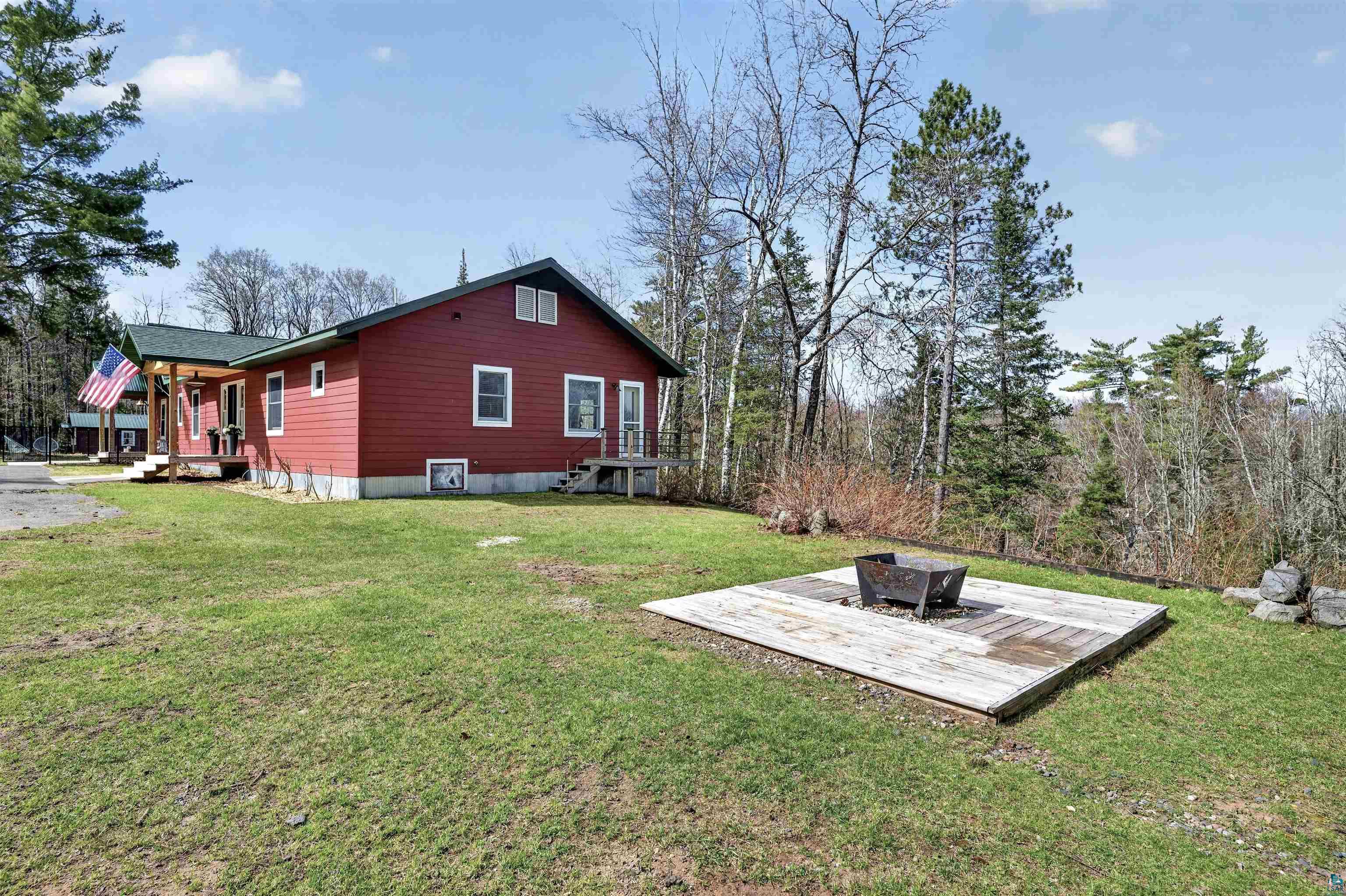 13885 Park Road Brule, WI 54820 - Photo 26 of 41 Red-sided residence featuring a dark green roof and white trim