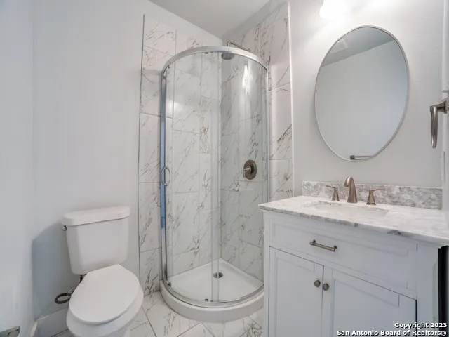 an empty room with wooden floor closet and windows