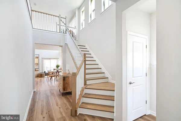 a view of entryway and hall with wooden floor