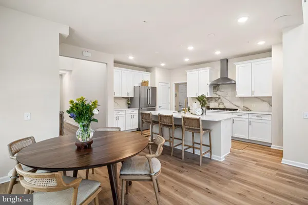 a kitchen with a table and chairs in it