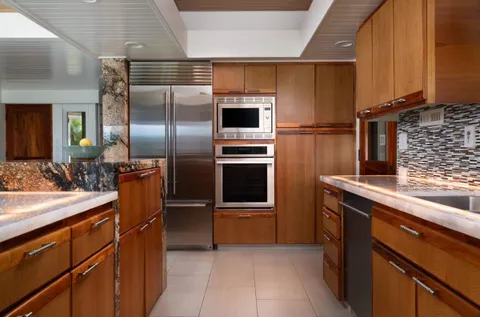 a living room with patio furniture and a floor to ceiling window