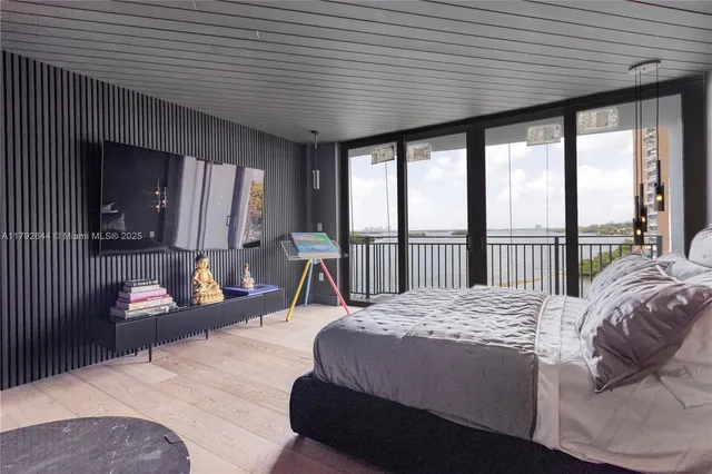 a large bedroom with a large bed and a large window