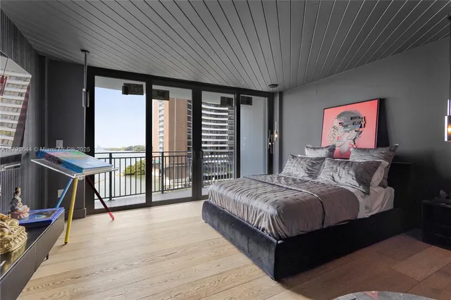 a spacious bedroom with a large bed and a balcony
